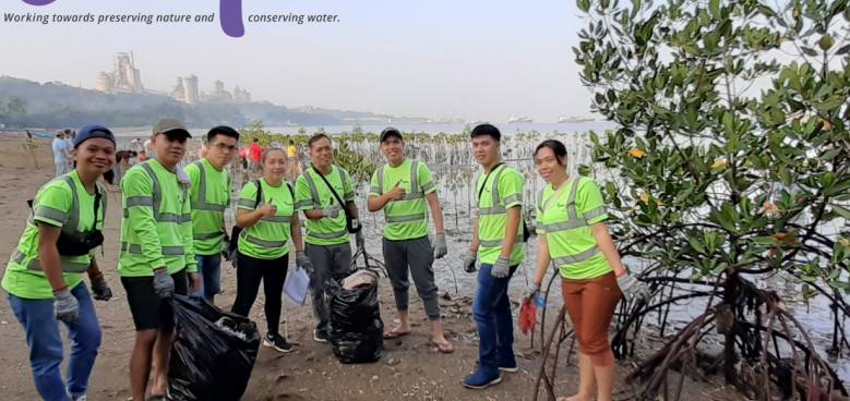 holcim employees at the lugait coast in misamis oriental for international coastal clean up day